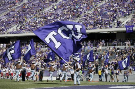 Members of the TCU cheering team celebrate a score against Kansas in the second half of an NCAA college football game, Saturday, Oct. 12, 2013, in Fort Worth, Texas. TCU won 27-17. (AP Photo/Tony Gutierrez)