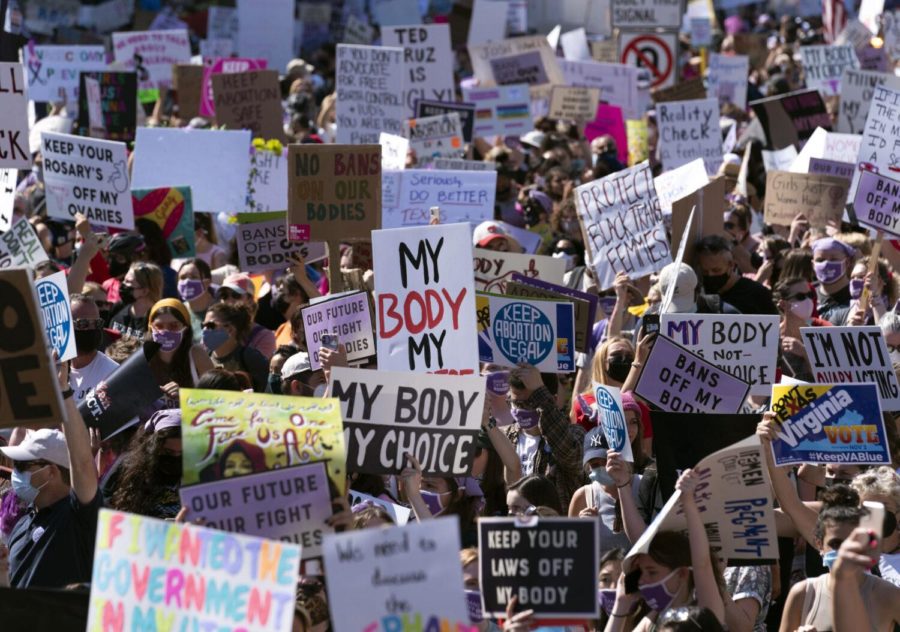 Thousands of demonstrators march on Pennsylvania Avenue during the Womens March in Washington, Saturday, Oct. 2, 2021. (AP Photo/Jose Luis Magana)
