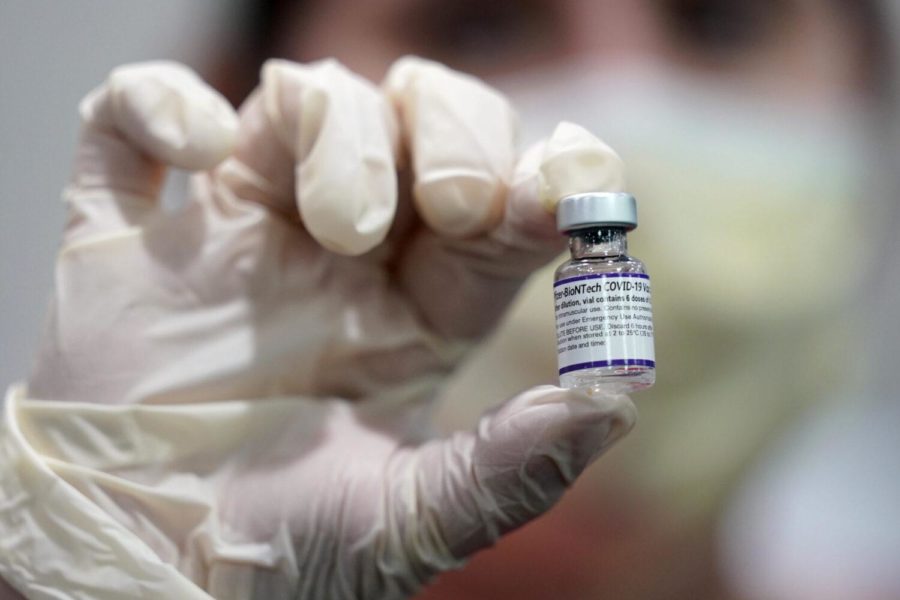 FILE - A healthcare worker holds a vial of the Pfizer COVID-19 vaccine at Jackson Memorial Hospital in Miami, in this Tuesday, Oct. 5, 2021, file photo. Pfizer asked the U.S. government Thursday, Oct. 7, 2021, to allow use of its COVID-19 vaccine in children ages 5 to 11 -- and if regulators agree, shots could begin within a matter of weeks. (AP Photo/Lynne Sladky, File)