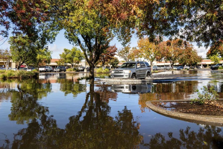 A+driver+crosses+a+flooded+parking+lot+in+Oroville%2C+Calif.%2C+on+Monday%2C+Oct.+25%2C+2021.+A+massive+storm+barreled+toward+Southern+California+on+Monday+after+causing+flooding+across+the+northern+half+of+the+state.+%28AP+Photo%2FNoah+Berger%29