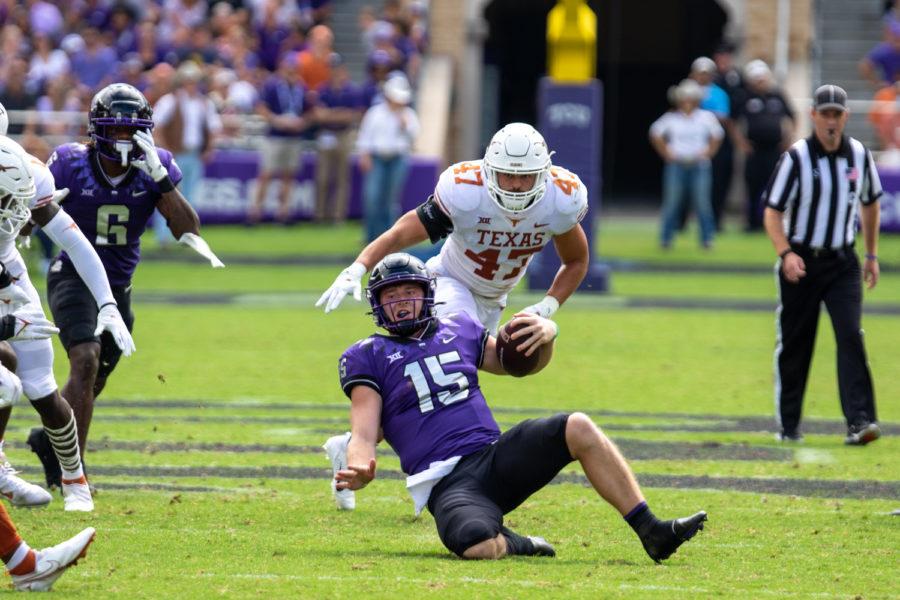 TCU quarterback Max Duggan (15) slides to avoid getting hit in the Frogs 32-27 loss to the Texas Longhorns in Fort Worth on Oct. 2, 2021. (Esau Rodriguez/Staff Photographer)
