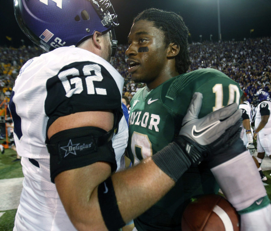 Baylor quarterback Robert Griffin III (10) and TCU offensive tackle Jeff Olson (62) talk after their NCAA college football game in Waco, Texas, Friday, Sept. 2, 2011. Baylor won 50-48.  (AP Photo/LM Otero)