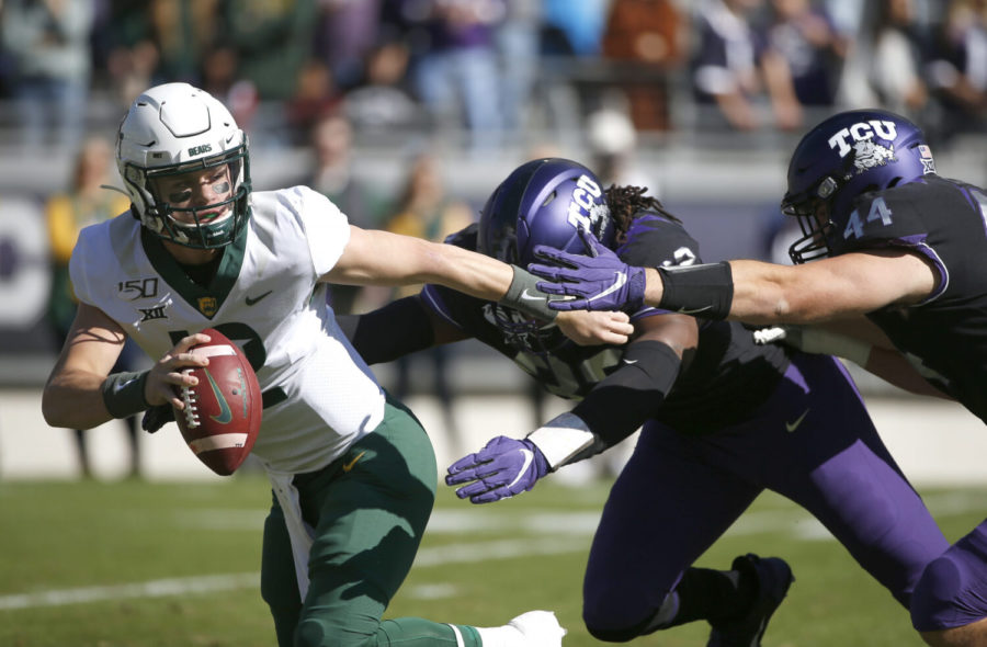 FILE - In this Nov. 9, 2019, file photo, Baylor quarterback Charlie Brewer (12) tries to avoid the rush of TCU defensive ends Ochaun Mathis (32) and Colt Ellison (44) during the first half of an NCAA college football game in Fort Worth, Texas. Baylor is playing its first home game in more than a month when instate rival TCU visits on Saturday, Oct. 31, 2020. The Bears are still trying to figure out their identity on offense, which has been difficult with a new coach in an uneven season interrupted by the pandemic. (AP Photo/Ron Jenkins, File)