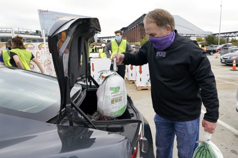TCU+head+football+coach+Gary+Patterson+places+frozen+turkeys+into+the+trunk+of+a+vehicle+as+he+joined+other+volunteers+distributing+food+during+a+Tarrant+Area+Food+Bank+mobile+pantry+event+in+Arlington%2C+Texas%2C+Friday%2C+Nov.+20%2C+2020.+Thanksgiving+holiday+food+items+were+distributed+to+over+5%2C000+families+during+the+event+that+took+place+in+a+parking+lot+outside+AT%26T+Stadium.+%28AP+Photo%2FTony+Gutierrez%29