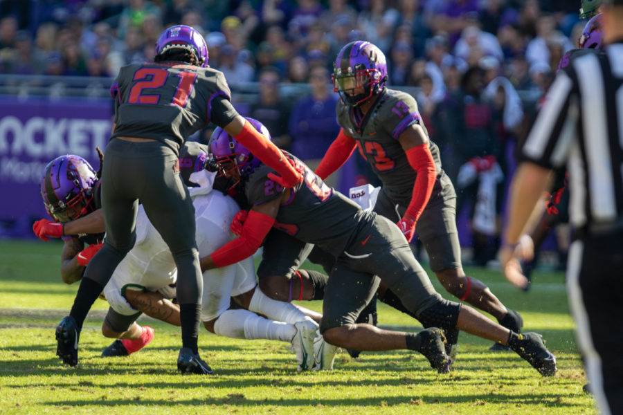 Several TCU defenders combine to make a tackle in TCUs 30-28 win over No. 12 Baylor on Nov. 6, 2021. (Esau Rodriguez/Staff Photographer)