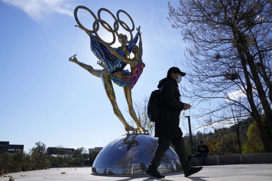 A visitor to the Shougang Park walks past the a sculpture for the Beijing Winter Olympics in Beijing, China, Tuesday, Nov. 9, 2021. China on Monday, Dec. 6, 2021, threatened to take firm countermeasures if the U.S. proceeds with a diplomatic boycott of Februarys Beijing Winter Olympic Games. (AP Photo/Ng Han Guan)