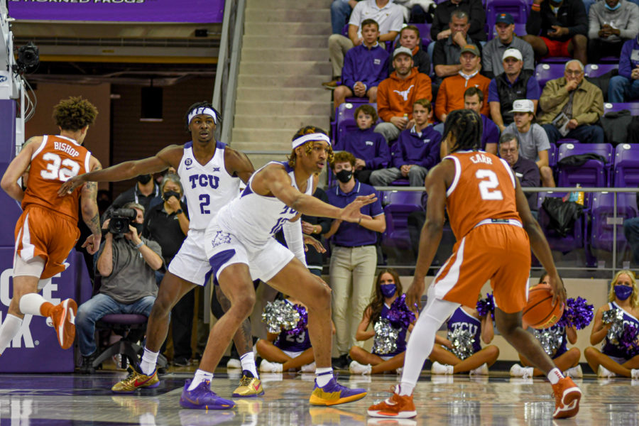 TCU forward Xavier Cork (12) defends Texas guard Marcus Carr (2) in the Frogs 73-50 home loss to the Longhorns on Jan. 25, 2022. (Esau Rodriguez Olvera/Head Staff Photographer)