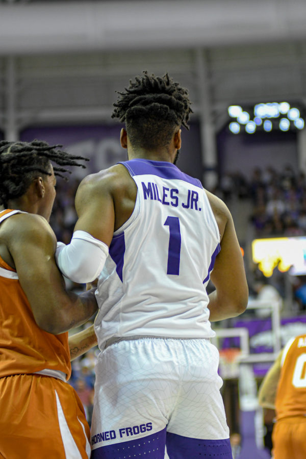 TCU guard Mike Miles (1) is defended in TCU's blowout loss to Texas in Fort Worth, Texas, on Jan. 25, 2022. (Esau Rodriguez Olvera/Head Staff Photographer)