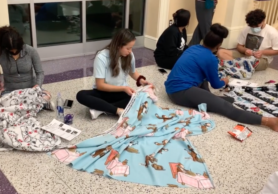 Members of TheCrew and the Crafting and Knitting Club work on a service project for Project Linus, a non-profit that provides children-in-need with homemade blankets. 