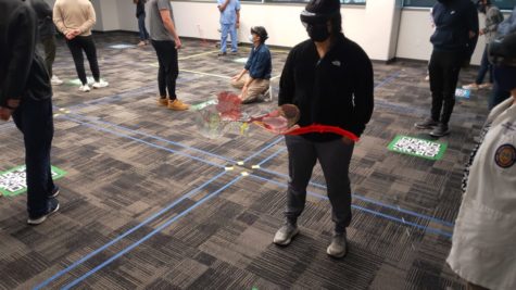 Isabella Amado examines holographic anatomy structures of the head and neck using HoloLens Technology. (Photo courtesy of Jonathan Babirak/Taken through HoloLens goggles).