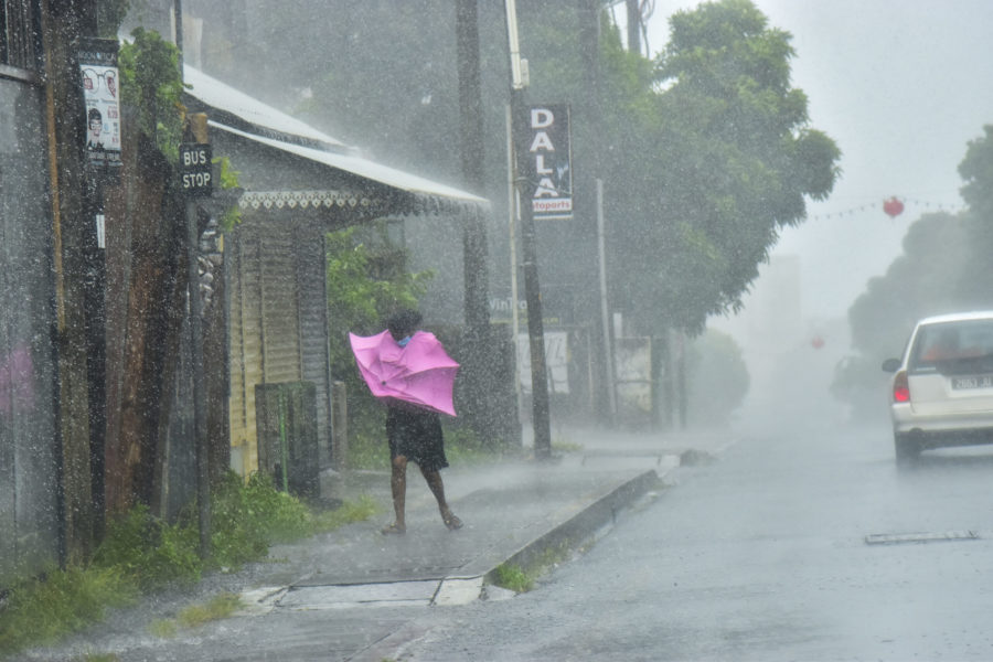 A woman fights Gale force winds in the Indian Ocean Island of Mauritius Wednesday Feb. 2, 2022. Forecasts say Tropical Cyclone Batsirai is increasing in intensity and is expected to pass north of the Indian Ocean island nation of Mauritius on Wednesday evening and make landfall in central Madagascar on Saturday afternoon.The Global Disaster Alert and Coordination System says Batsirai has been upgraded and classified as Category 4.(Beekash Roopun/Lexpress Maurice via AP)