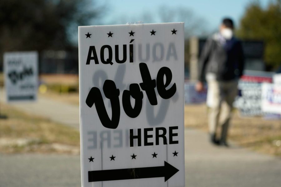 Voters leave an early voting poll site, Monday, Feb. 14, 2022, in San Antonio. Early voting in Texas began Monday. (AP Photo/Eric Gay)