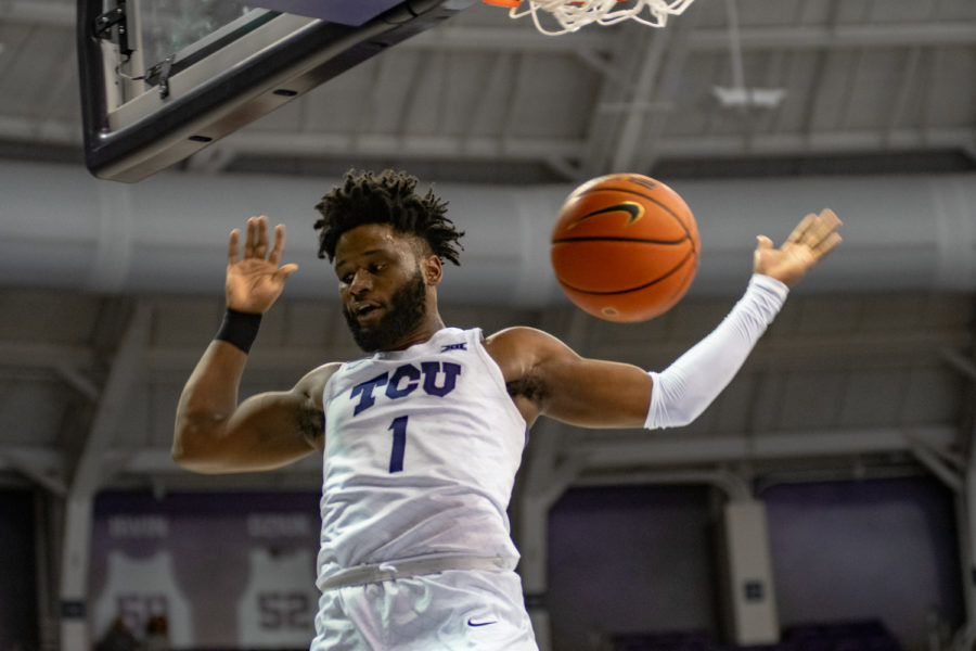 TCU guard Mike Miles (1) flushes a dunk during TCU's win over West Virginia in Fort Worth, Texas, on Feb. 21, 2022. Miles had 15 points in the game. (Esau Rodriguez Olvera/Head Staff Photographer)