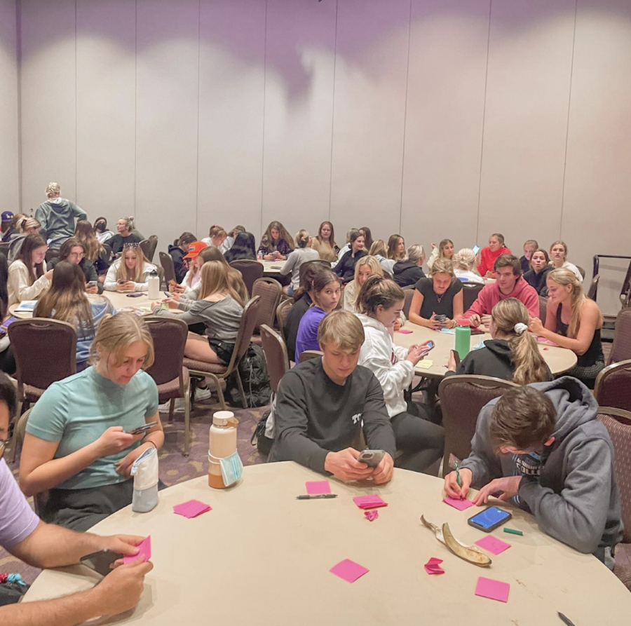 Students gathered at a Tuesday night meeting writing positive messages on sticky notes to put up around campus. (Photo Courtesy of TCU Impact of Words)