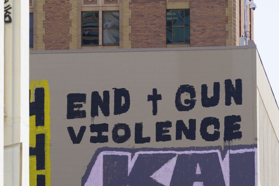 A sign calling for the end of gun violence is displayed on Wednesday, April 6, 2022, on the side of a building near the scene of a recent mass shooting in Sacramento, Calif. Multiple people were killed and injured in the shooting that occurred Sunday, April 3, 2022. (AP Photo/Rich Pedroncelli)