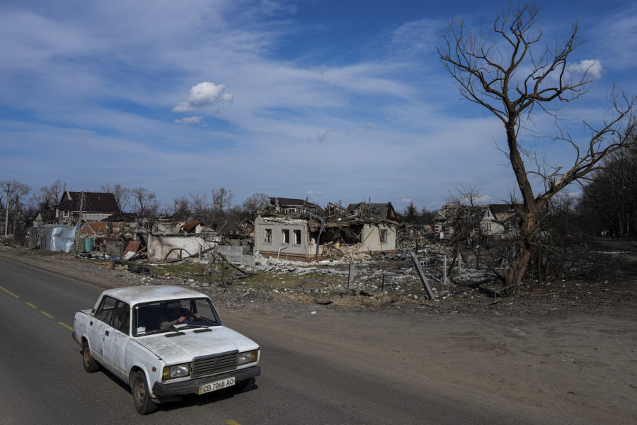 A car moves in a street past damaged houses in Chernihiv, Ukraine, Thursday, April 7, 2022. Ukraine is telling residents of its industrial heartland to leave while they still can after Russian forces withdrew from the shattered outskirts of Kyiv to regroup for an offensive in the countrys east. (AP Photo/Evgeniy Maloletka)
