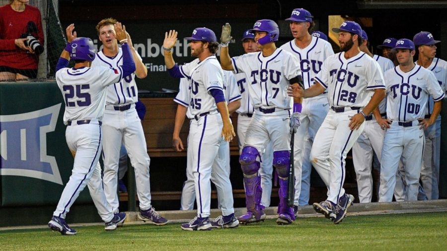 Shortstop Tommy Sacco scores and gives high fives to his teammates on May 26, 2022. (Photo courtesy of GoFrogs.com)