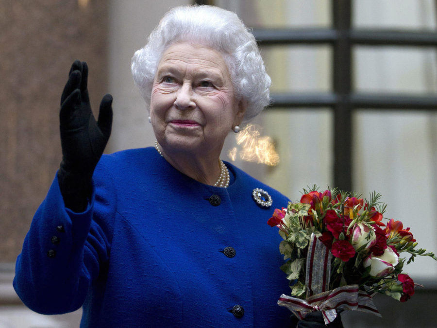 FILE - In this Tuesday, Dec. 18, 2012 file photo, Britain's Queen Elizabeth II looks up and waves to members of staff of The Foreign and Commonwealth Office as she ends an official visit which is part of her Jubilee celebrations in London. (AP Photo/Alastair Grant Pool, File)