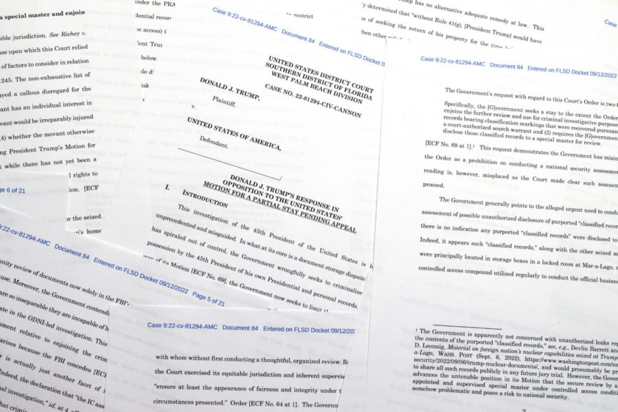 Pages from a court filing by former President Donald Trumps lawyers urging a federal judge to keep in place a directive that temporarily halted key aspects of the Justice Departments criminal probe into top-secret information seized by the FBI at Trumps Mar-a-Lago estate, is photographed Monday, Sept. 12, 2022. (AP Photo/Jon Elswick)