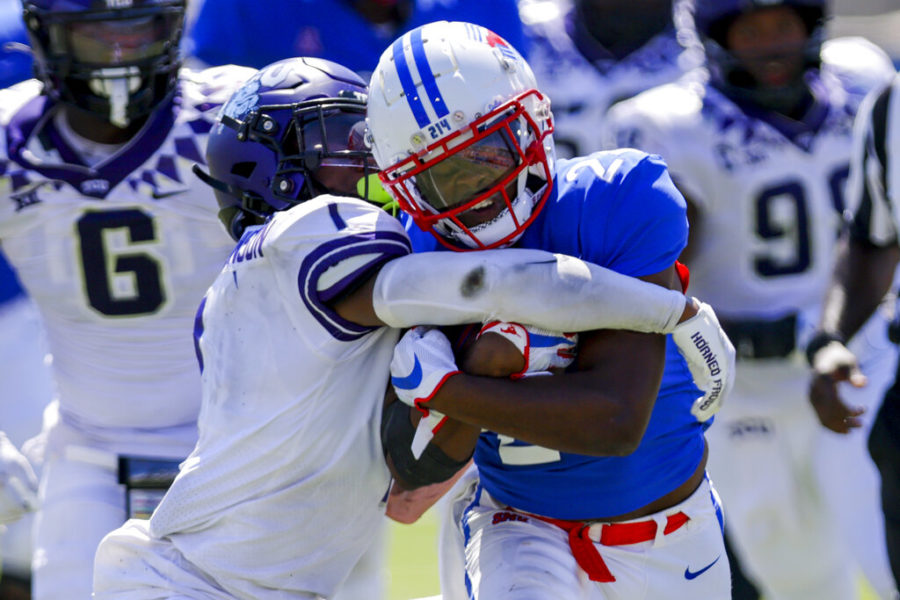 SMU running back Velton Gardner, right, is tackled by TCU corner TreVius Hodges-Thompson during the second half of an NCAA college game on Saturday, Sept. 24, 2022, in Dallas, Texas. (AP Photo/Gareth Patterson)