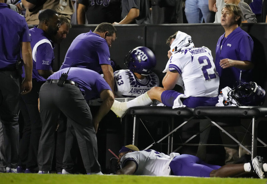 TCU quarterback Chandler Morris, right, is attended to by trainers after being injured while throwing a pass in the second half of an NCAA college football game against Colorado Friday, Sept. 2, 2022, in Boulder, Colo. (AP Photo/David Zalubowski)
