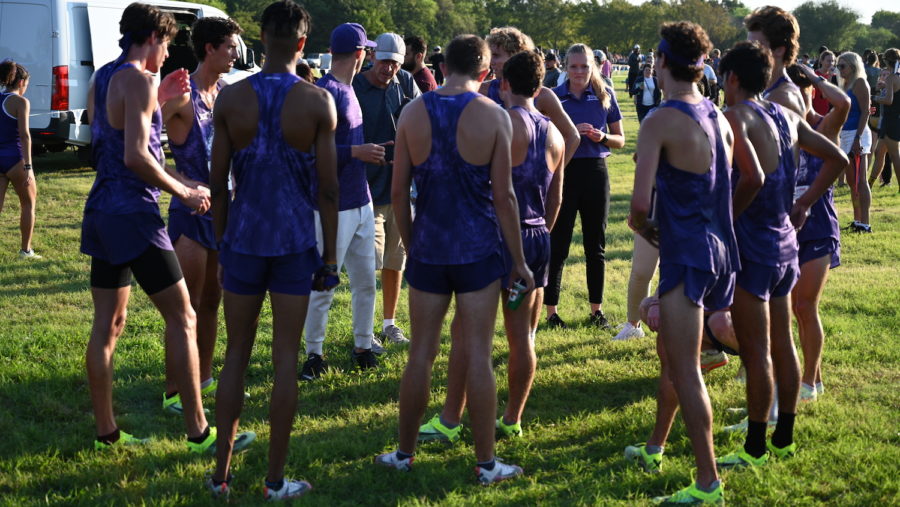 Coaches Robinson and Cooke brief the mens cross country team after they placed second as a team at the UTA Gerald Richey Invite. (Micah Pearce/Staff Photographer)