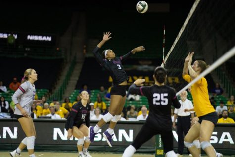 TCU middle blocker Mykayla Myers, in Waco, Texas, leaps to execute a kill, assisted by setter Callie Williams on Sept. 21, 2022. (Photo courtesy of GoFrogs.com)