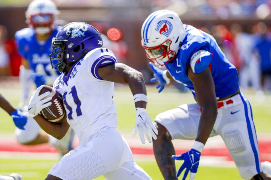 TCU wide receiver Derius Davis (11) runs past SMU defender Jamoi Hodge (6) during the second half of an NCAA college game on Saturday, Sept. 24, 2022, in Dallas, Texas. (AP Photo/Gareth Patterson)