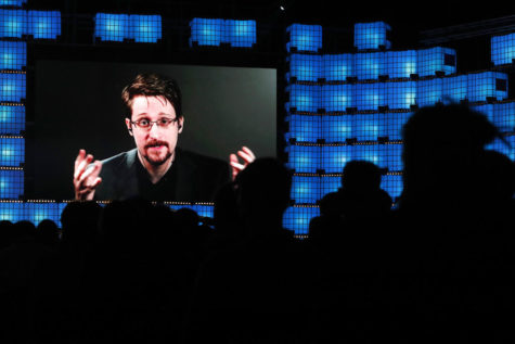 FILE - In this Nov. 4, 2019, file photo, former U.S. National Security Agency contractor Edward Snowden addresses attendees through video link at the Web Summit technology conference in Lisbon. A judge ruled on Dec. 17, 2019, that Snowden violated secrecy agreements with the U.S. government that allow it to claim proceeds from a memoir he published. Federal Judge Liam OGrady ruled that Snowden is liable for breach of contract with the government because he published Permanent Record,” without submitting it for a pre-publication review. (AP Photo/Armando Franca, File)