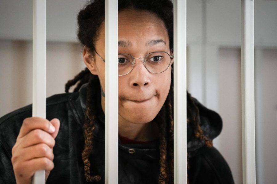 FILE - WNBA star and two-time Olympic gold medalist Brittney Griner speaks to her lawyers standing in a cage at a court room prior to a hearing, in Khimki just outside Moscow, Russia, Tuesday, July 26, 2022. A Russian court has on Tuesday, Oct. 23 started hearing American basketball star Brittney Griners appeal against her nine-year prison sentence for drug possession. (AP Photo/Alexander Zemlianichenko, Pool, File)