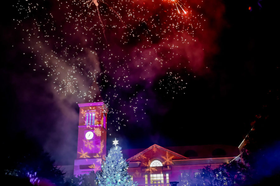 Color from the first of many fireworks stay in the air over the BLUU and the. newly lit tree.  (Sophia Allen/Staff Photographer)