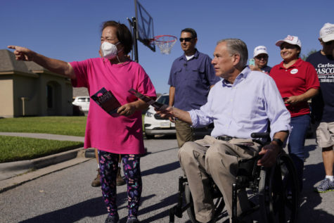 Texas Gov. Greg Abbott, right, canvasses for votes, Saturday, Oct. 1, 2022, in Harlingen, Texas. As Democrats embark on another October blitz in pursuit of flipping Americas biggest red state, Republicans are taking a swing of their own: Making a play for the mostly Hispanic southern border on Nov. 8 after years of writing off the region that is overwhelmingly controlled by Democrats. (AP Photo/Eric Gay)