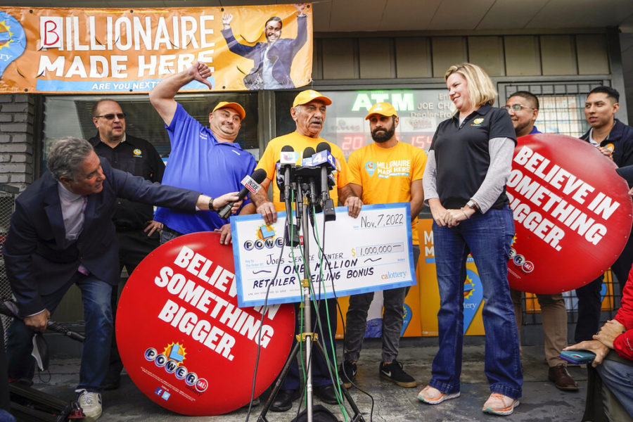 CA Lottery officials present a retailer selling bonus check to Joe Chahayed at Joe’s Service Center in Altadena, northeast of Los Angeles Tuesday, Nov. 8, 2022. Chahayed’s gas station sold the Powerball winning ticket. (AP Photo/Damian Dovarganes)