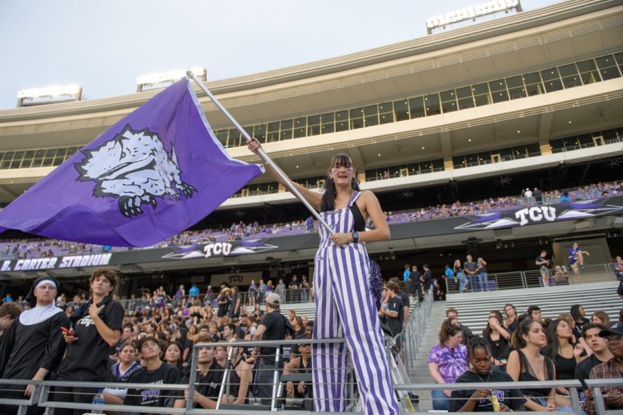 TCU Head Dutchman Erinn Callaghan waves a Horned Frog flag before TCU's matchup against undefeated Kansas State. Oct. 22, 2022. 