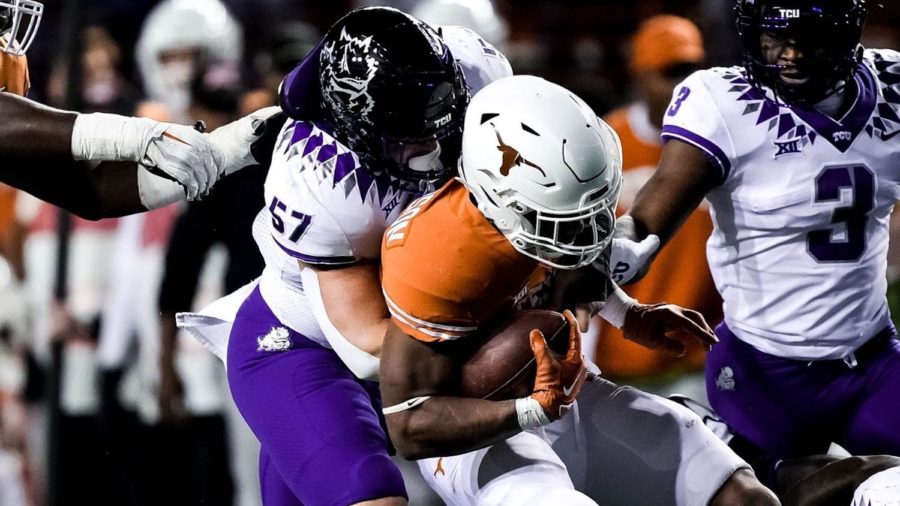 TCU+linebacker+Johnny+Hodges+wraps+up+Texas+star+running+back+Bijan+Robinson.+The+Frog+defense+limited+him+to+29+yards+rushing.+Nov.+12%2C+2022.+%28Photo+courtesy+of%3A+gofrogs.com%29