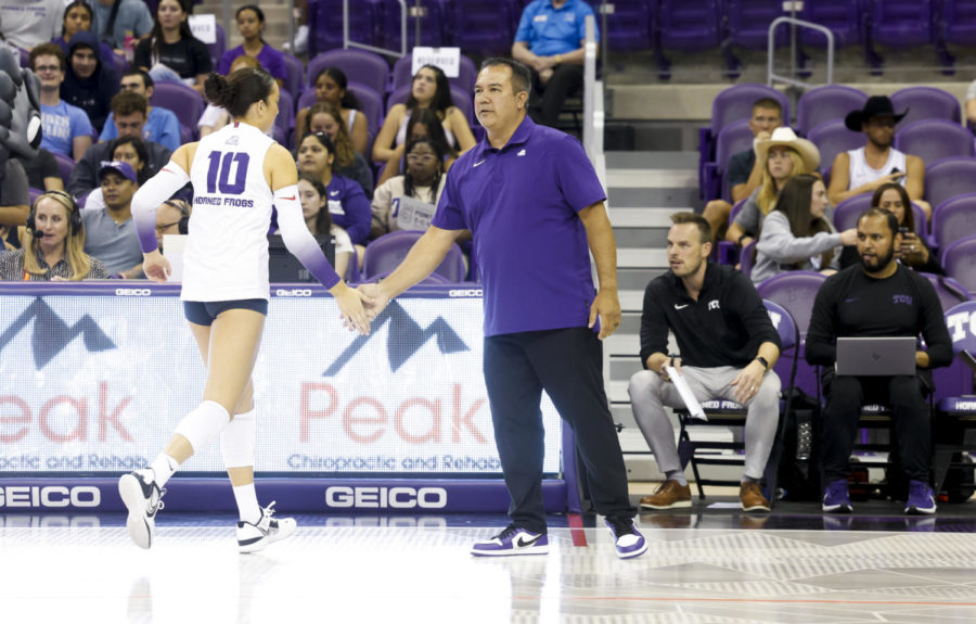 TCU volleyball head coach Jason Williams high fives daughter and setter Callie Williams in between sets. (Photo/Sharon Ellman)