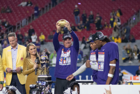 TCU head coach Sonny Dykes holds up the Fiesta Bowl trophy after beating No. 2 Michigan in the College Football Playoffs. Dec. 31, 2022. (Tristen Smith/Staff Photographer)