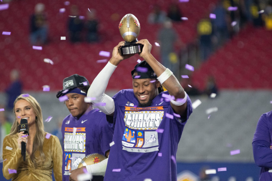 TCU+wide+receiver+Quentin+Johnston+lifts+the+Fiesta+Bowl+offensive+MVP+trophy+after+a+dominant+performance+against+Michigan+on+Dec.+31%2C+2022.+%28Tristen+Smith%2FStaff+Photographer%29
