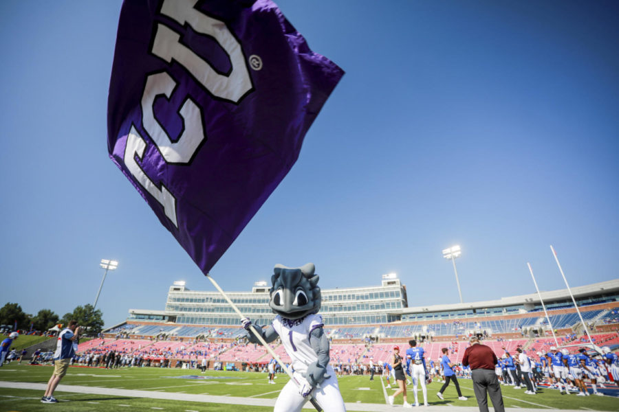 TCU mascot Superfrog flies a team flag during the pregame of an NCAA college game against SMU on Saturday, Sept. 24, 2022, in Dallas, Texas. (AP Photo/Gareth Patterson)