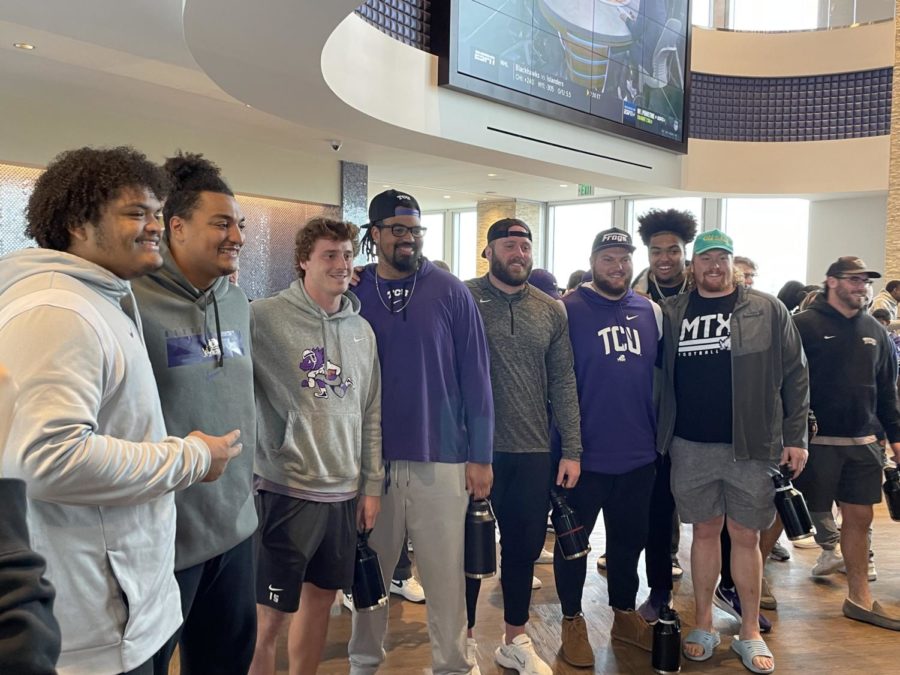 TCU football players pose for a photograph after learning they will face Michigan in the College Football Playoffs. (Micah Pearce/TCU360)