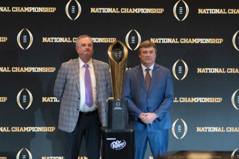 TCU and Georgia head coaches Sonny Dykes and Kirby Smart, respectively, stand with the national championship trophy, Jan. 8, 2023. (Tristen Smith/Staff Photographer)