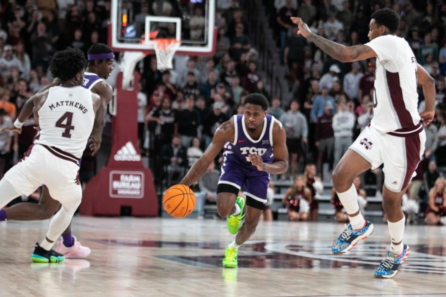 Guard Shahada Wells dribbles past defenders vs Mississippi State on Jan. 28, 2023. (Photo courtesy of GoFrogs.com)