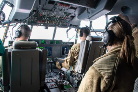 A cadet from TCU Air Force ROTC sits in the crew seat of the cockpit of a C-130J during an orientation flight. (Lance Sanders/Staff Writer)