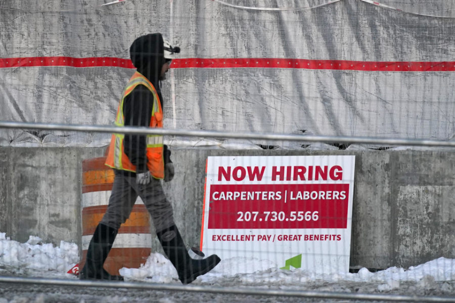 A+worker+passes+a+hiring+sign+at+a+construction+site%2C+Wednesday%2C+Jan.+25%2C+2023%2C+in+Portland%2C+Maine.+On+Thursday%2C+the+Labor+Department+reports+on+the+number+of+people+who+applied+for+unemployment+benefits+last+week.+%28AP+Photo%2FRobert+F.+Bukaty%29
