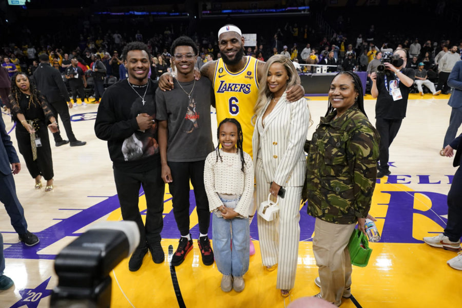 Los Angeles Lakers forward LeBron James, center, poses with his family after he passed Kareem Abdul-Jabbar to become the NBAs all-time leading scorer during the second half of an NBA basketball game against the Oklahoma City Thunder Tuesday, Feb. 7, 2023, in Los Angeles. (AP Photo/Ashley Landis)