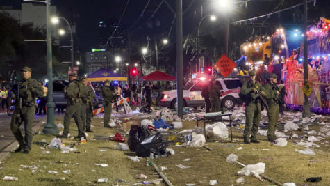 Police work the scene of a shooting at the Krewe of Bacchus parade on Sunday, Feb. 19, 2023.  Five people were shot, including a young girl, during a Mardi Gras parade in New Orleans, police said, and a suspect was in custody.  (David Grunfeld/The Times-Picayune/The New Orleans Advocate via AP)