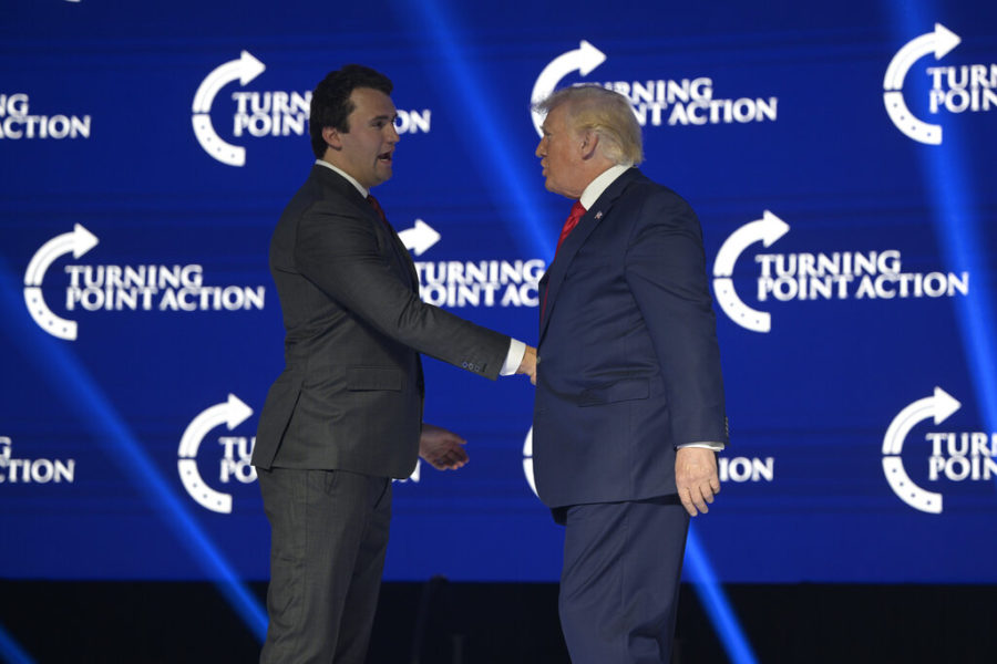 Former President Donald Trump, right, shakes hands with Turning Point CEO Charlie Kirk before speaking during the Turning Point USA Student Action Summit, Saturday, July 23, 2022, in Tampa, Fla. (AP Photo/Phelan M. Ebenhack)