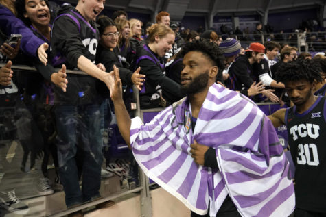 TCU s Mike Miles Jr., center, and Darius Ford (30) celebrate with fans after their NCAA college basketball game aginst Oklahoma, Tuesday, Jan. 24, 2023, in Fort Worth, Texas. (AP Photo/Tony Gutierrez)