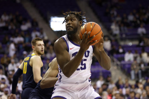 TCU center Souleymane Doumbia (25) works beneath the basket as West Virginias Mohamed Wague, center rear, and Erik Stevenson (10) defend in the first half of an NCAA college basketball game, Tuesday, Jan. 31, 2023, in Fort Worth, Texas. (AP Photo/Ron Jenkins)