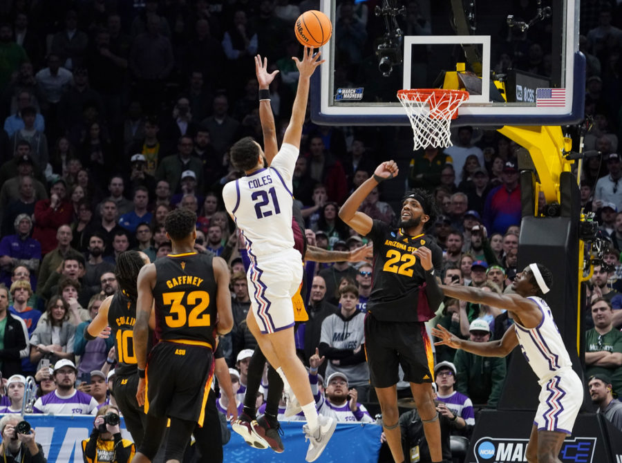 TCU forward JaKobe Coles (21) drives the lane for a basket past Arizona State forwards Alonzo Gaffney (32) and Warren Washington (22) during the second half of a first-round college basketball game in the mens NCAA Tournament on Friday, March 17, 2023, in Denver. (AP Photo/John Leyba)